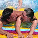 Man and woman playing in the pool.