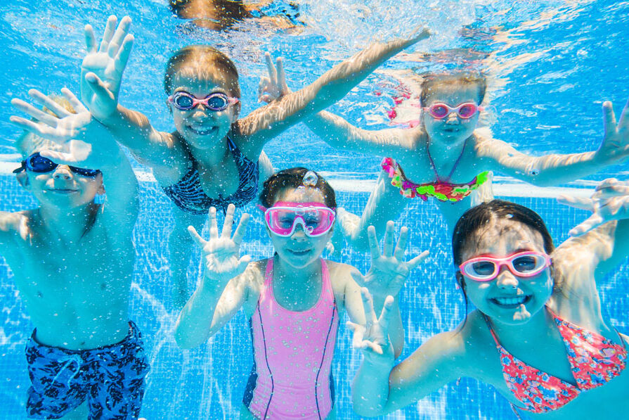 Young boys and girls playing under water.